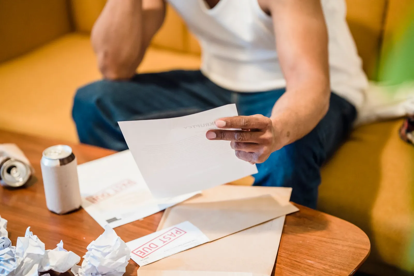 A man reviewing a stack of unpaid bills