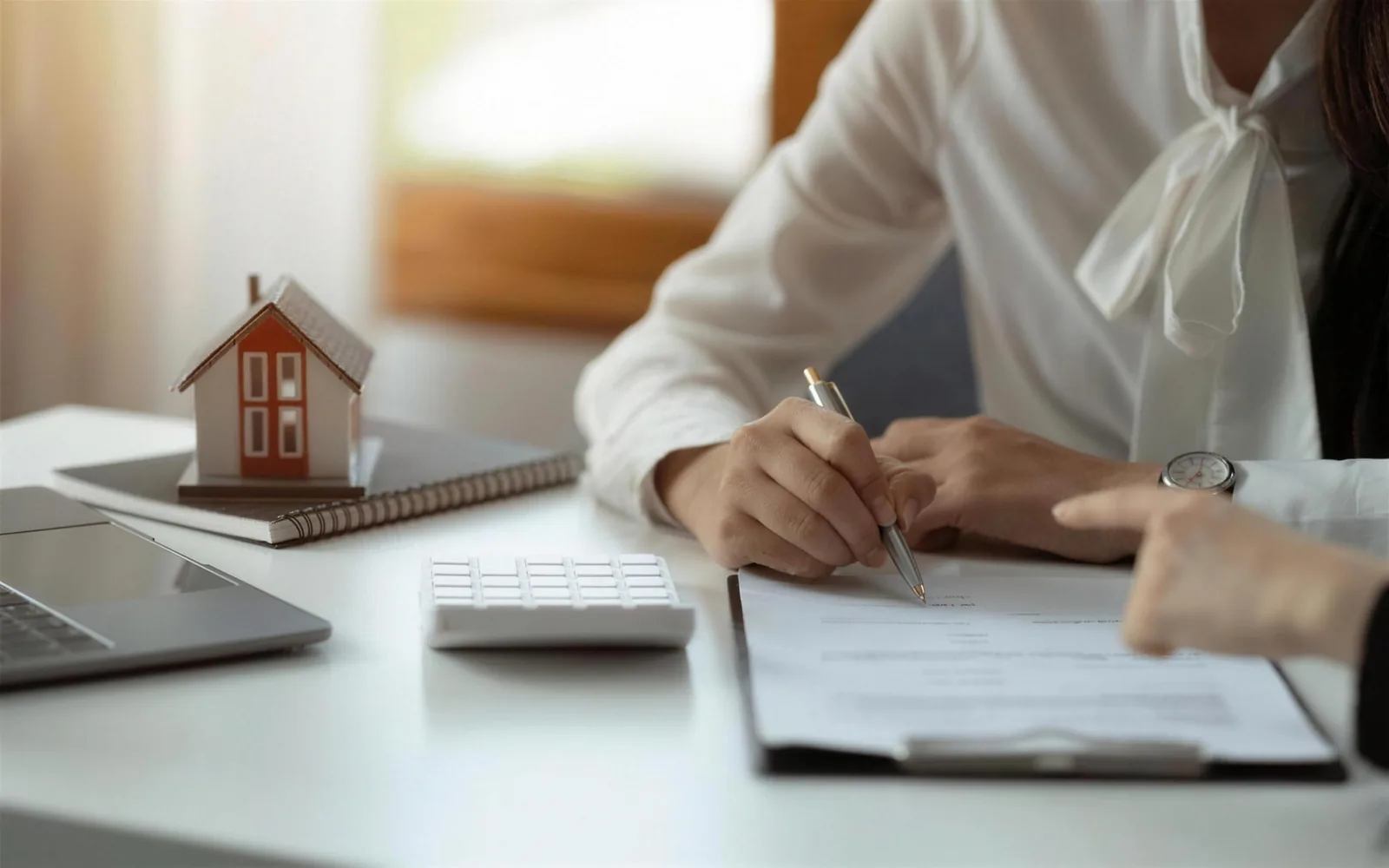 A Credit Gym specialist going through paperwork with a client at a desk