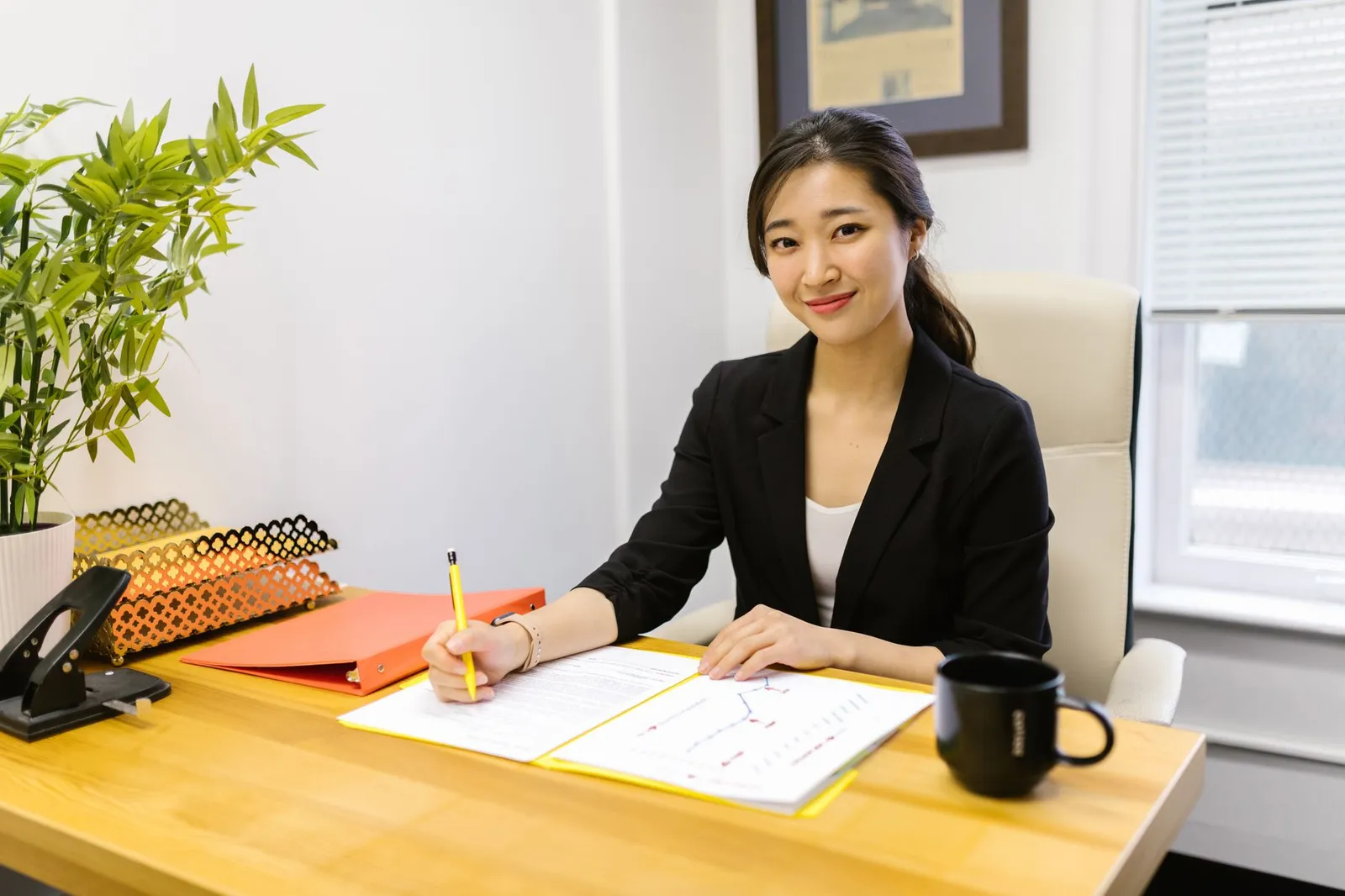 A woman working calmly at her desk, paperwork under control